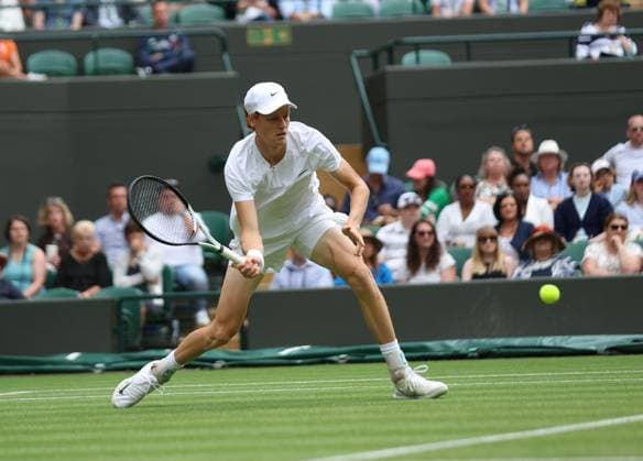 Italy s Jannik Sinner plays a forehand in his match against Columbia s Daniel Elah Galan on day seven of the 2023 Wimbledon championships in London on Sunday, July 9, 2023.  LON20230709299 HUGOxPHILPOTT