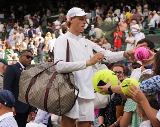 Tennis - 2023 Wimbledon Championships - Week One - Day Seven - All England lawn Tennis & Racquet Club, Wimbledon - Sunday 9th Mens singles - Yannick Sinner (ITA) v Daniel Elahi Galan (COL) Yannick Sinner with his Gucci Bag, signs autographs after his victory 