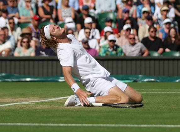 Russian Andrey Rublev reacts in pain in his match against Kazakhstan s Alexander Bublik on day seven of the 2023 Wimbledon championships in London on Sunday, July 9, 2023.  LON2023070946 HUGOxPHILPOTT