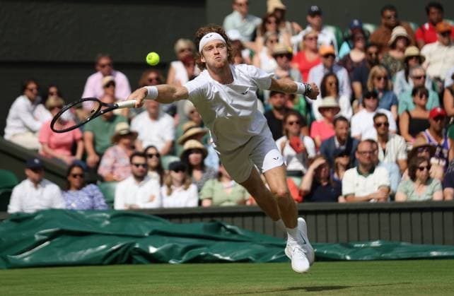 Russian Andrey Rublev plays a forehand in his match against Kazakhstan s Alexander Bublik on day seven of the 2023 Wimbledon championships in London on Sunday, July 9, 2023.  LON2023070930 HUGOxPHILPOTT