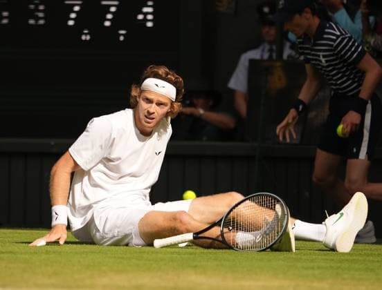Tennis - 2023 Wimbledon Championships - Week One - Day Seven - All England lawn Tennis & Racquet Club, Wimbledon - Sunday 9th Mens singles - Andrey Rublev v Alexander Bublik (KAZ) Andrey Rublev scores a winning point as he falls over on the grass 
