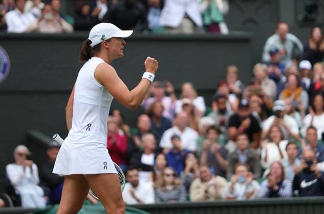 Poland s Iga Swiatek celebrates victory in her match against Switzerland s Belinda Bencic on day seven of the 2023 Wimbledon championships in London on Sunday, July 09, 2023.  LON2023070976 HUGOxPHILPOTT