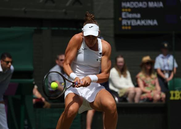 10th July 2023; All England Lawn Tennis and Croquet Club, London, England: Wimbledon Tennis Tournament; Beatriz Haddad Maia (BRA) with a backhand shot to Elena Rybakina (KAZ)  ActionPlus12529837 JohnxPatrickxFletcher