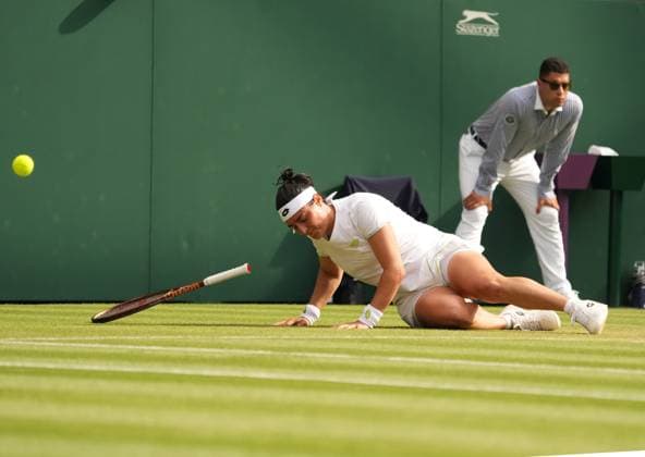 Tennis - 2023 Wimbledon Championships - Week Two - Day Eight - All England lawn Tennis & Racquet Club, Wimbledon - Monday 10th Ladies singles - Ons Jabeur (TUN) v Petra Kvitova (CZE) Ons Jabeur slips on the grass 