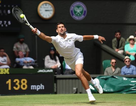 Serbian Novak Djokovic plays a forehand in his match against Poland s Herbert Hurkacz on day eight of the 2023 Wimbledon championships in London on Monday, July 10, 2023.  LON2023071097 HUGOxPHILPOTT