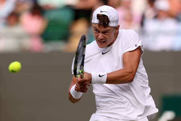 10th July 2023; All England Lawn Tennis and Croquet Club, London, England: Wimbledon Tennis Tournament; Holger Rune plays a backhand shot to Grigor Dimitrov  ActionPlus12529984 ShaunxBrooks