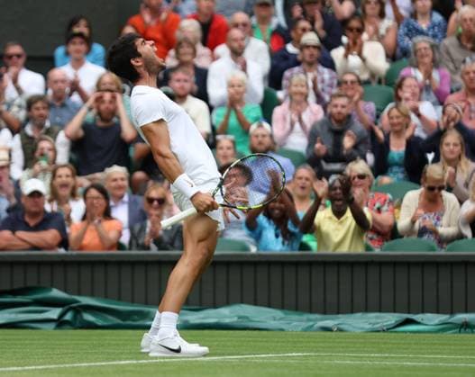 Spain s Carloss Alcaraz celebrates a point in his match against Italy s Matteo Berrettini on day eight of the 2023 Wimbledon championships in London on Monday, July 10, 2023.  LON20230710109 HUGOxPHILPOTT