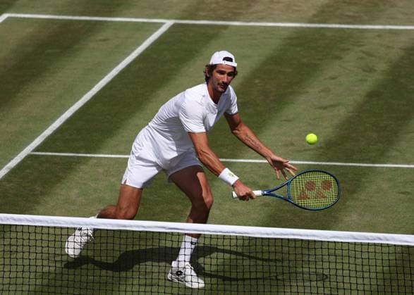11th July 2023; All England Lawn Tennis and Croquet Club, London, England: Wimbledon Tennis Tournament; Lloyd Harris (RSA) with a backhand shot to Horacio Zeballos (ARG) mens doubles round of 16  ActionPlus12530079 JohnxPatrickxFletcher