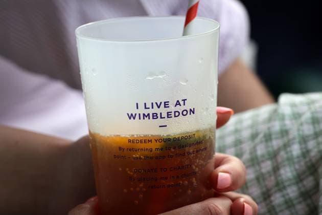 11th July 2023; All England Lawn Tennis and Croquet Club, London, England: Wimbledon Tennis Tournament; Spectator holding a Wimbledon recycle cup filled with Pimms displaying "I Live At Wimbledon"  ActionPlus12530320 JohnxPatrickxFletcher