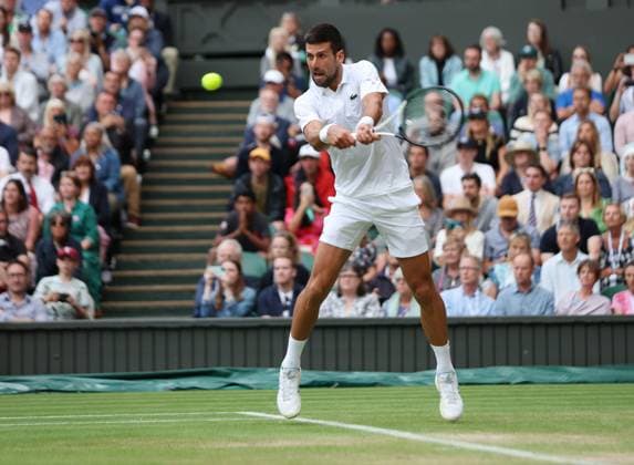 Serbian Novak Djokovic plays a backhand in his Men s Quarter-Final match against Russian Andrey Rublev at the 2023 Wimbledon championships in London on Tuesday, July 11, 2023.  LON2023071180 HUGOxPHILPOTT
