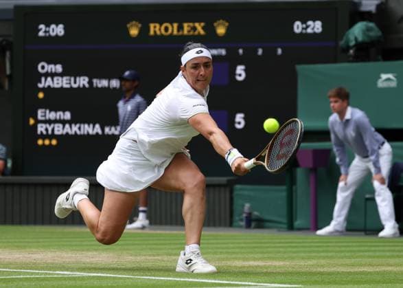 12th July 2023; All England Lawn Tennis and Croquet Club, London, England: Wimbledon Tennis Tournament; Ons Jabeur (TUN) with a backhand shot to Elena Rybakina (KAZ)  ActionPlus12530627 JohnxPatrickxFletcher