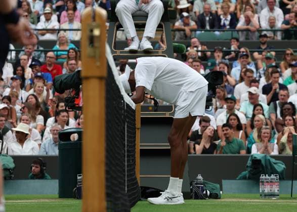 12th July 2023; All England Lawn Tennis and Croquet Club, London, England: Wimbledon Tennis Tournament; Christopher& xa0;Eubanks (USA) runs into the net exhausted after his shot at the net to Daniil& xa0;Medvedev (RUS ) goes wide  ActionPlus12530767 JohnxPatrickxFletcher