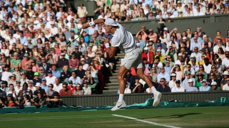 Denmark s Holger Rune serves in his Men s quarterfinals match against Spain s Carlos Alcaraz at the 2023 Wimbledon championships in London on Wednesday, July 12, 2023.  LON2023071258 HUGOxPHILPOTT