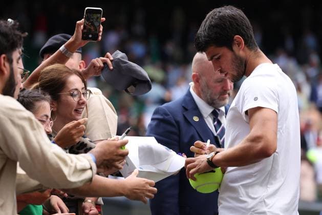 12th July 2023; All England Lawn Tennis and Croquet Club, London, England: Wimbledon Tennis Tournament; Carlos Alcaraz signs autographs for fans after he wins his match against Holger Rune  ActionPlus12530800 ShaunxBrooks