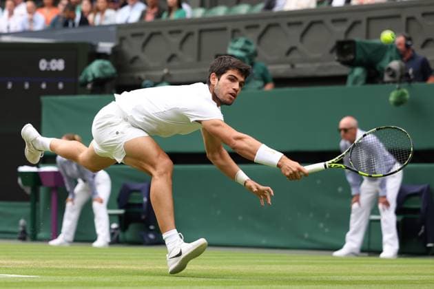 12th July 2023; All England Lawn Tennis and Croquet Club, London, England: Wimbledon Tennis Tournament; Carlos Alcaraz returns the serve of Holger Rune  ActionPlus12530860 ShaunxBrooks