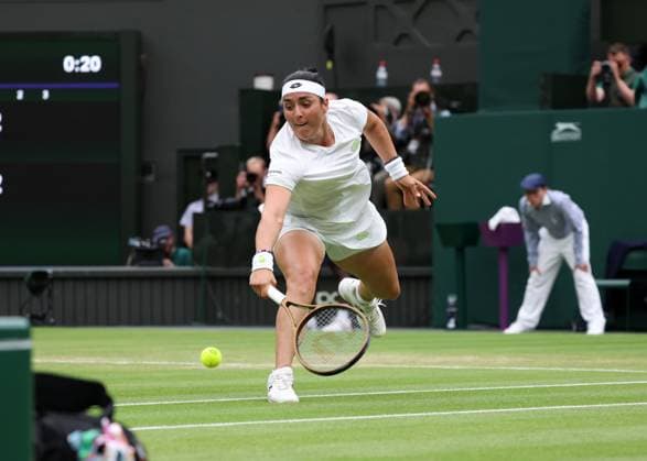 13th July 2023; All England Lawn Tennis and Croquet Club, London, England: Wimbledon Tennis Tournament; Ons Jabeur (TUN) sprints to with a backhand shot to Aryna Sabalenka (BLR)  ActionPlus12531113 JohnxPatrickxFletcher