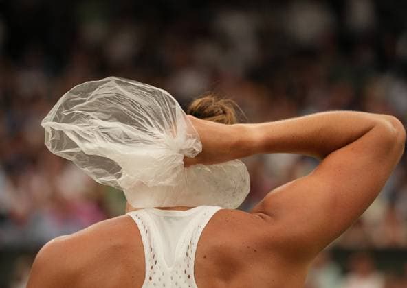 Tennis - 2023 Wimbledon Championships - Week Two - Day Eleven - All England lawn Tennis & Racquet Club, Wimbledon - Thursday 13th Ladies singles semi final Ons Jabeur (TUN) v Aryna Sabalenka Aryna Sabalenka puts the ice bag on her neck 