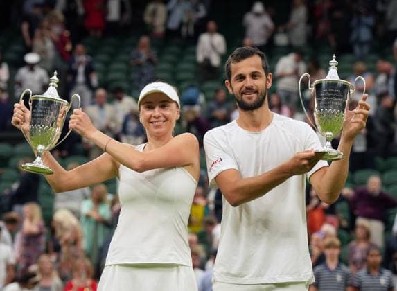 Tennis - 2023 Wimbledon Championships - Week Two - Day Eleven - All England lawn Tennis & Racquet Club, Wimbledon - Thursday 13th Mixed Doubles final Mate Pavings (CRO) and Lyudmyia Kirchenok (UKR) V Joran Vliegen (BEL) v Yifan Xu (CHN) Winners Mate Pavings (CRO) and Lyudmyia Kirchenok (UKR) with their trophies 