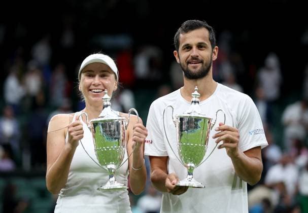 (230714) -- LONDON, July 14, 2023 -- Mate Pavic (R) Lyudmyla Kichenok pose for photos during the awarding ceremony after winning the mixed doubles final match between Xu Yifan of China Joran Vliegen of Belgium and Mate Pavic of Croatia Lyudmyla Kichenok of Ukraine at Wimbledon tennis Championship in London, Britain, on July 13, 2023. ) (SP)BRITAIN-LONDON-TENNIS-WIMBLEDON-DAY 11 LixYing 