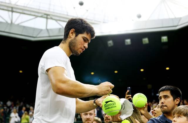 Mandatory Credit: Photo by Kieran McManus Shutterstock (14009604gi) Carlos Alcaraz of Spain signs autographs as he leaves the court after winning his Semi Final match. Wimbledon Tennis Championships, Day 12, The All England Lawn Tennis and Croquet Club, London, UK - 14 Jul 2023 Wimbledon Tennis Championships, Day 12, The All England Lawn Tennis and Croquet Club, London, UK - 14 Jul 2023  Copyright: xKieranxMcManus Shutterstockx 14009604gi