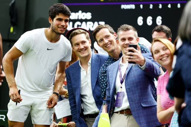 Mandatory Credit: Photo by Kieran McManus Shutterstock (14009604gj) Carlos Alcaraz of Spain poses for selfies as he leaves the court after winning his Semi Final match. Wimbledon Tennis Championships, Day 12, The All England Lawn Tennis and Croquet Club, London, UK - 14 Jul 2023 Wimbledon Tennis Championships, Day 12, The All England Lawn Tennis and Croquet Club, London, UK - 14 Jul 2023  Copyright: xKieranxMcManus Shutterstockx 14009604gj