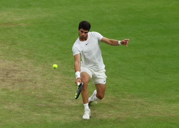 14th July 2023; All England Lawn Tennis and Croquet Club, London, England: Wimbledon Tennis Tournament; Carlos Alcaraz (ESP) with a backhand shot to Daniil Medvedev (RUS)  ActionPlus12531319 JohnxPatrickxFletcher