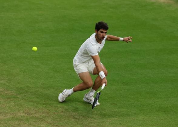 14th July 2023; All England Lawn Tennis and Croquet Club, London, England: Wimbledon Tennis Tournament; Carlos Alcaraz (ESP) with a backhand shot to Daniil Medvedev (RUS)  ActionPlus12531324 JohnxPatrickxFletcher
