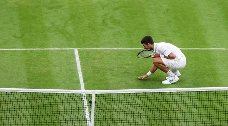 (230715) -- LONDON, July 15, 2023 -- Novak Djokovic kisses the grass to celebrate after the men s singles semifinal between Novak Djokovic of Serbia and Jannik Sinner of Italy at Wimbledon tennis Championship in London, Britain, on July 14, 2023. ) (SP)BRITAIN-LONDON-TENNIS-WIMBLEDON-DAY 12 HanxYan 