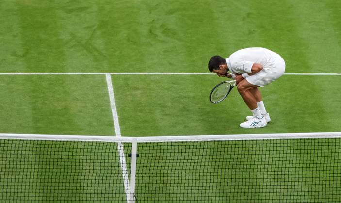(230715) -- LONDON, July 15, 2023 -- Novak Djokovic kisses the grass to celebrate after the men s singles semifinal between Novak Djokovic of Serbia and Jannik Sinner of Italy at Wimbledon tennis Championship in London, Britain, on July 14, 2023. ) (SP)BRITAIN-LONDON-TENNIS-WIMBLEDON-DAY 12 HanxYan 