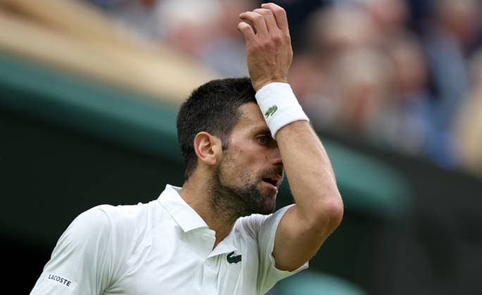 (230715) -- LONDON, July 15, 2023 -- Novak Djokovic reacts during the men s singles semifinal between Novak Djokovic of Serbia and Jannik Sinner of Italy at Wimbledon tennis Championship in London, Britain, on July 14, 2023. ) (SP)BRITAIN-LONDON-TENNIS-WIMBLEDON-DAY 12 LixYing 