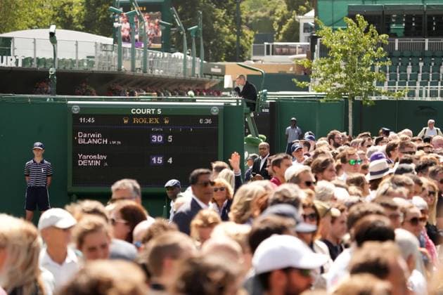 Tennis - 2023 Wimbledon Championships - Week Two - Day Thirteen - All England lawn Tennis & Racquet Club, Wimbledon -Saturday 15th Boys Semi final - Henry Searle (GBR) v Cooper Williams (USA) Crowds watch on the outside courts 