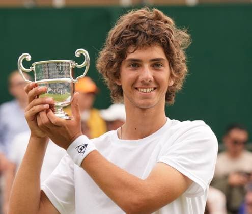 Tennis - 2023 Wimbledon Championships - Week Two - Day Fourteen - All England lawn Tennis & Racquet Club, Wimbledon - Sunday 16th Boys singles U™14 final - Mark Cuban (GBR) v Svit Suljic (SLO) Mark Cuban (GBR) with his winners trophy 
