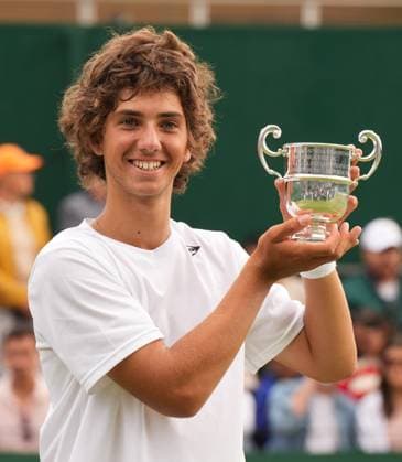 Tennis - 2023 Wimbledon Championships - Week Two - Day Fourteen - All England lawn Tennis & Racquet Club, Wimbledon - Sunday 16th Boys singles U™14 final - Mark Cuban (GBR) v Svit Suljic (SLO) Mark Cuban (GBR) with his winners trophy 