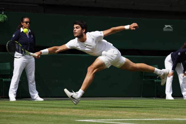 16th July 2023; All England Lawn Tennis and Croquet Club, London, England: Wimbledon Tennis Tournament; Mens singles final on centre court Novak Djokovic versus Carlos Alcaraz; Djokovic stretches to return  ActionPlus12532012 JohnxPatrickxFletcher