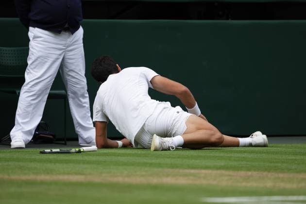 16th July 2023; All England Lawn Tennis and Croquet Club, London, England: Wimbledon Tennis Tournament; Mens singles final on centre court Novak Djokovic versus Carlos Alcaraz; Alcaraz slips awkwardly on court  ActionPlus12532090 JohnxPatrickxFletcher