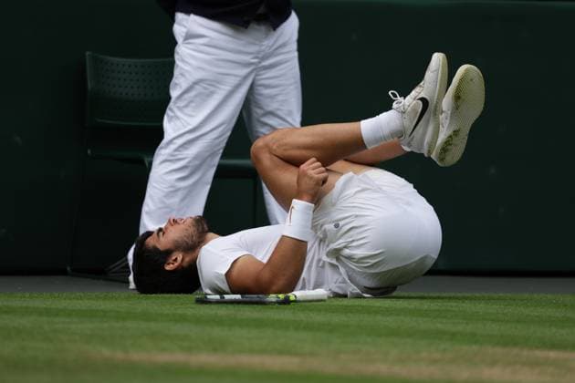 16th July 2023; All England Lawn Tennis and Croquet Club, London, England: Wimbledon Tennis Tournament; Mens singles final on centre court Novak Djokovic versus Carlos Alcaraz; Alcaraz slips awkwardly on court  ActionPlus12532092 JohnxPatrickxFletcher