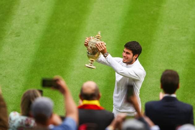 Mandatory Credit: Photo by Kieran McManus Shutterstock (14011306ea) Carlos Alcaraz celebrates with the Wimbledon Trophy Wimbledon Tennis Championships, Day 14, The All England Lawn Tennis and Croquet Club, London, UK - 16 Jul 2023 Wimbledon Tennis Championships, Day 14, The All England Lawn Tennis and Croquet Club, London, UK - 16 Jul 2023  Copyright: xKieranxMcManus Shutterstockx 14011306ea