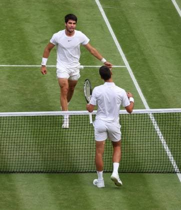 Spain s Carlos Alcaraz embraces his opponent after victory in the Wimbledon Men s Final match against Serbian Novak Djokovic at the 2023 Wimbledon championships in London on Sunday, July 16, 2023. Alcaraz won the match 1-6,7-6,6-1,3-6,6-4.  LON2023071610 HUGOxPHILPOTT