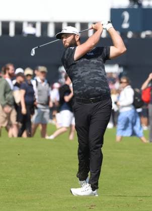 Spain s Jon Rahm hits a fairway iron on the third hole on the first day at the 151st Open Championship at Royal Liverpool Golf Club in Hoylake, England on Thursday, July 20, 2023.  LON20230720110 HUGOxPHILPOTT
