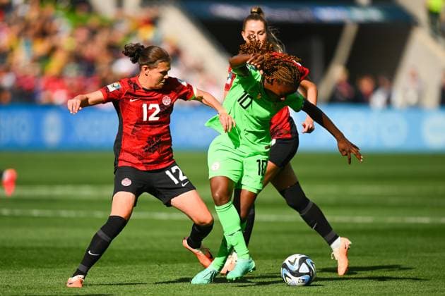 WWC23 CANADA NIGERIA, Christy Ucheibe of Nigeria (centre) fights for the ball with Christine Sinclair of Canada during the FIFA Women s World Cup 2023 soccer match between Nigeria and Canada at Melbourne Rectangular Stadium in Melbourne, Friday, July 21, 2023. ( NO ARCHIVING, EDITORIAL USE ONLY, NO USE IN BOOKS WITHOUT CONSENT MELBOURNE VICTORIA AUSTRALIA  Copyright: xMORGANxHANCOCKx 20230721001822507907 
