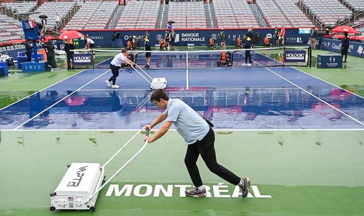 August 7, 2023, Montreal, PQ, Canada: Workers push water off centre court during a rain delay at the National Bank Open tennis tournament in Montreal, Monday, August 7, 2023. Canada News - August 7, 2023  - ZUMAc35_ 20230807_zaf_c35_052 Copyright: xGrahamxHughesx