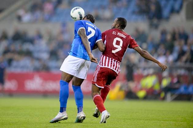 KRC Genk v Olympiacos - UEFA Europa League Qualifying GENK, BELGIUM - AUGUST 17 : McKenzie Mark defender of KRC Genk battles for the ball with Ayoub El Kaabi forward of Olympiacos FC during the second leg match of the UEFA Europa League season 2023 - 2024 third qualifying round between KRC Genk and Olympiacos on August 17, 2023 in Genk, BELGIUM, 17 08 2023 Genk BELGIUM  Copyright: xSesx