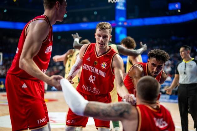 Basketball Okinawa 27 08 2023 FIBA Basketball World Cup 2023 Mens World Cup Preliminary Round Australia AUS Germany GER Andreas Obst Germany, No 42 and Maodo Lo Germany, No 04 Johannes Voigtmann Germany, No 07 help Daniel Theis Germany, No 10 get on his feet