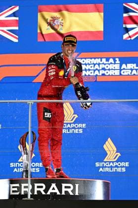 (230918) -- SINGAPORE, Sept. 18, 2023 -- Ferrari driver Carlos Sainz of Spain celebrates with champagne on the podium after winning the Formula One Singapore Grand Prix Night Race at the Marina Bay Street Circuit, Sept. 17, 2023. (Photo by Xinhua) (Photo by Xinhua) (SP)SINGAPORE-F1-SINGAPORE GRAND PRIX ThenxChihxWey 