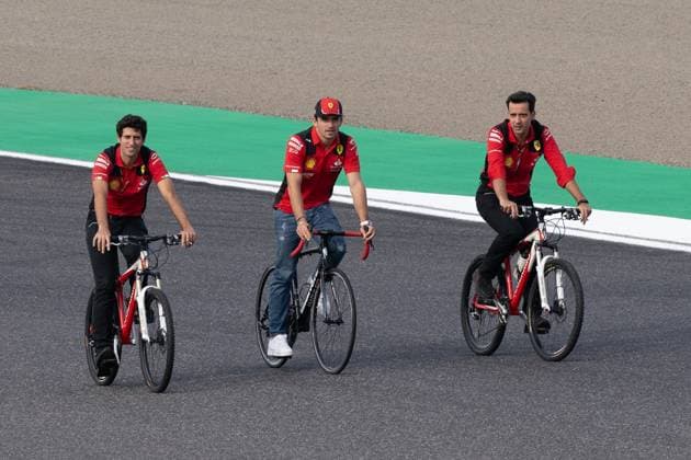 September 21, 2023, Suzuka, Mie Prefecture, Japan: CHARLES LECLERC (MON) of Ferrari 16 (center) arrives by bicycle to Turn 2 for a meeting called by Sebastian Vettel...A Buzzin Corner bee hive bee hotel constructed as an initiative by former F1 World Champion Sebastian Vettel during Preparation Day of the Formula 1 Lenovo Japanese Grand Prix. Vettel called a meeting of all the 20 starting grid drivers at Turn 2 to personalize the bee hotels and draw media attention to environmental conservation efforts. Suzuka Japan - ZUMAb177 20230921_aap_b177_078 Copyright: xTaidghxBarronx