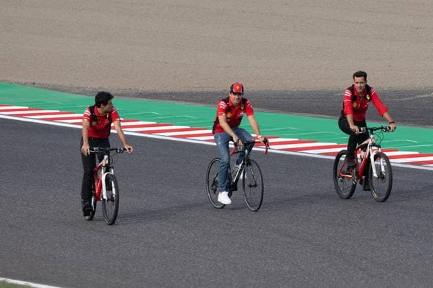 September 21, 2023, Suzuka, Mie Prefecture, Japan: CHARLES LECLERC (MON) of Ferrari 16 (center) arrives by bicycle to Turn 2 for a meeting called by Sebastian Vettel...A Buzzin Corner bee hive bee hotel constructed as an initiative by former F1 World Champion Sebastian Vettel during Preparation Day of the Formula 1 Lenovo Japanese Grand Prix. Vettel called a meeting of all the 20 starting grid drivers at Turn 2 to personalize the bee hotels and draw media attention to environmental conservation efforts. Suzuka Japan - ZUMAb177 20230921_aap_b177_093 Copyright: xTaidghxBarronx