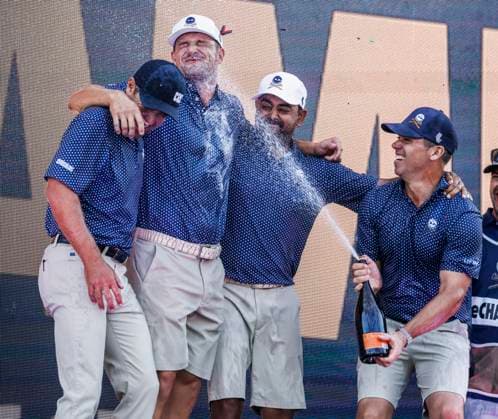 Paul Casey of England (R) sprays his teammages Charles Howell III of the US (L) Bryson DeChambeau of the US (2 L) and Anirban Lahiri of India (2R) after they won the team competition of the 2023 LIV Golf League tournament at Rich Harvest Farms in Sugar Grove, Illinois, on Sunday, September 24, 2023. Tournament play runs from September 22nd through the 24th.  SGI20230924835 TANNENxMAURY