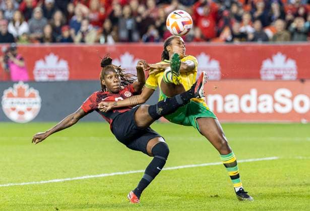 (230927) -- TORONTO, Sept. 27, 2023 -- Kadeisha Buchanan (L) of Canada vies with Paige Bailey of Jamaica during their Play-In series second leg match of the CONCACAF Women s Olympic Qualifying at BMO Field in Toronto, Canada, on Sept. 26, 2023. Canada women s national soccer team advanced to the Paris 2024 Olympic Games, Olympische Spiele, Olympia, OS on Tuesday. (Photo by Xinhua) (SP)CANADA-TORONTO-SOCCER-CONCACAF WOMEN S OLYMPIC QUALIFYING-PLAY-IN SERIES ZouxZheng 