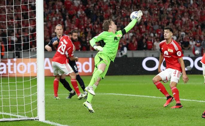 Goalkeeper Frederik Rönnow fists the ball away Sports Football Soccer UEFA Champions League UCL Men 2 Matchday Season 2023 2024 03 10 2023 1 FC Union Berlin FCU vs SC Braga Olympiastadion DFL regulations prohibit any use of photographs as image sequences and or quasi video