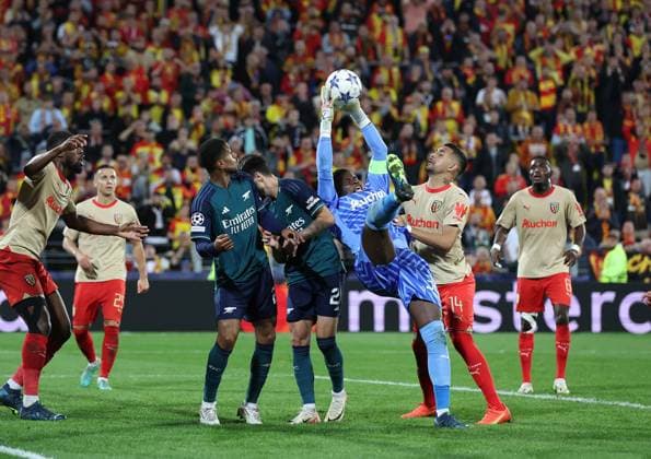 Lens, France, 3rd October 2023. Brice Samba of RC Lens claims the ball under pressure from Fabio Vieira of Arsenal during the UEFA Champions League match at the Estadio Bollaert Delelis, Lens. Picture credit should read: David Klein Sportimage EDITORIAL USE ONLY. No use with unauthorised audio, video, data, fixture lists, club league logos or live services. Online in-match use limited to 120 images, no video emulation. No use in betting, games or single club league player publications. SPI-2623-0075